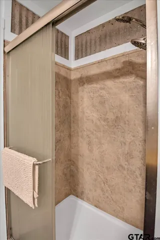 a bathroom with a shower and a tub