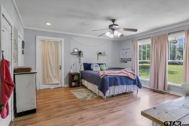 a spacious bedroom with a bed and a chandelier