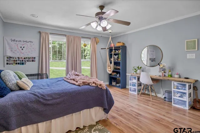 a bedroom with a bed a bookshelf and a chandelier