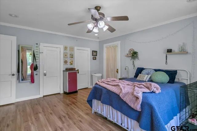 a bedroom with a bed and wooden floor