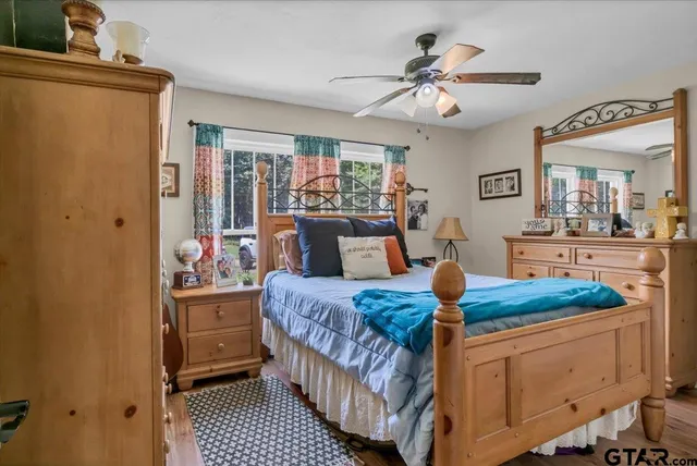a bedroom with bed and a chandelier