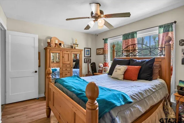 a bedroom with furniture and wooden floor