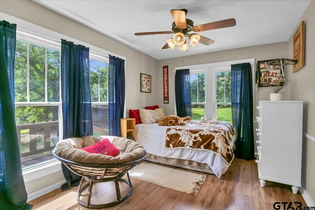 a bed sitting in a bedroom next to a large window