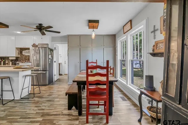 a dining room with furniture and wooden floor