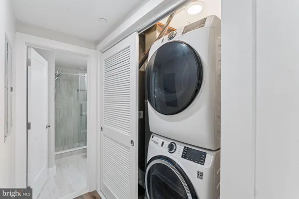 a view of a hallway with washer and dryer
