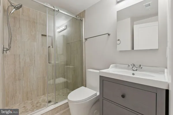 a bathroom with a sink toilet and shower