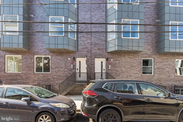 a front view of a house with parking space