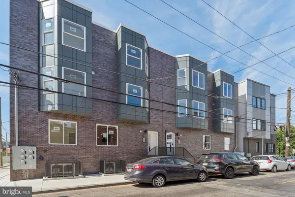 a car parked in front of a brick building
