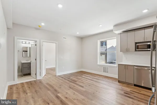 a kitchen with stainless steel appliances a refrigerator and a stove top oven