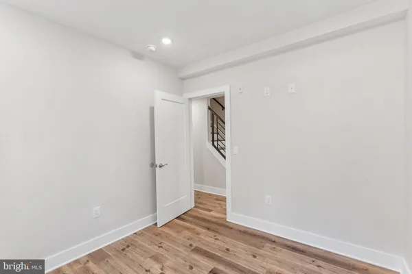a view of hallway with wooden floor