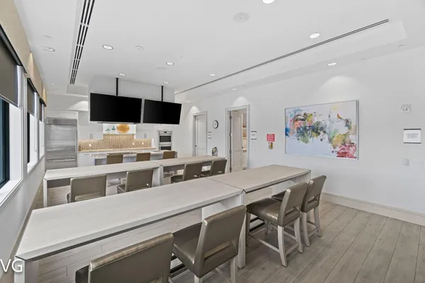 a large kitchen with kitchen island a sink stainless steel appliances and cabinets