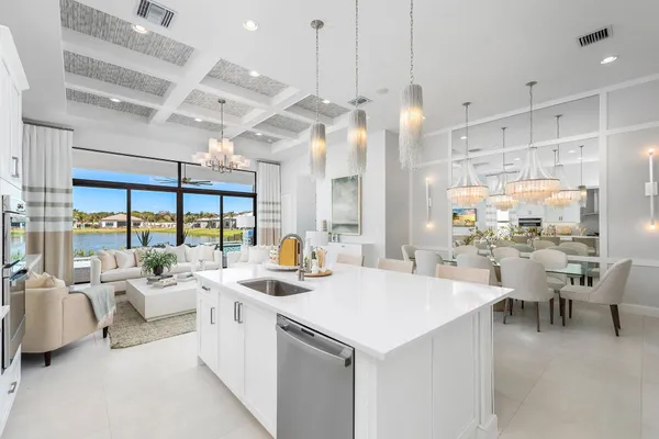 a large room with lots of white furniture