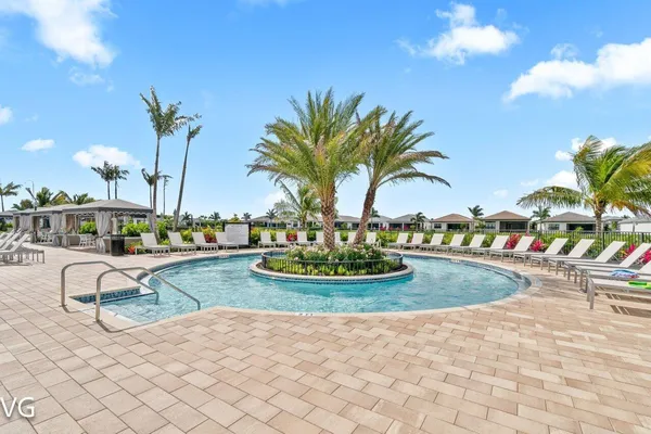 a view of a swimming pool and lounge chairs
