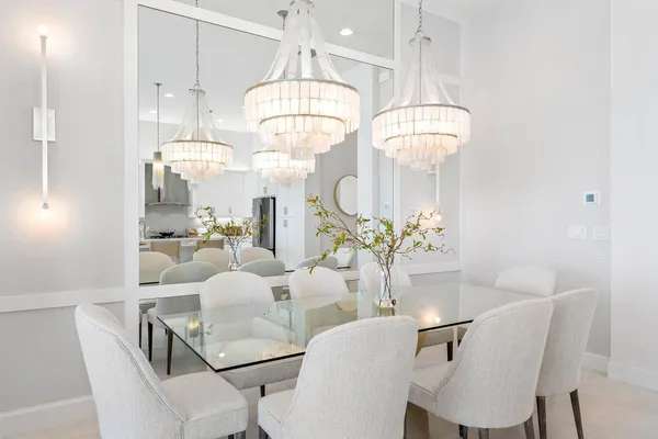 a view of a dining room with furniture a chandelier and wooden floor