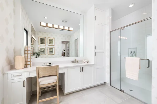 a spacious bathroom with a sink a mirror and a shower