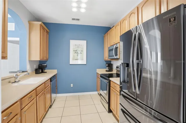 a kitchen with a refrigerator sink and stove
