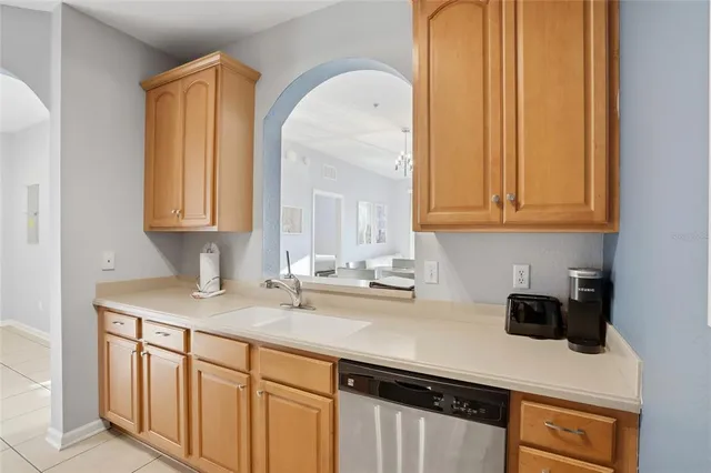 a kitchen with stainless steel appliances granite countertop a sink a stove and a microwave