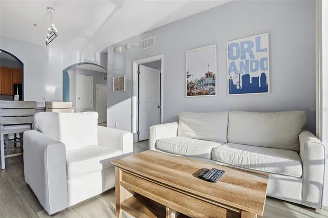 a living room with furniture and wall paintings