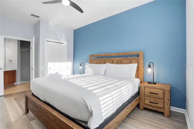 a bedroom with a bed and wooden floor