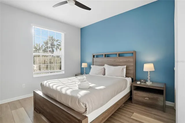 a large bed sitting in a bedroom next to a lamp