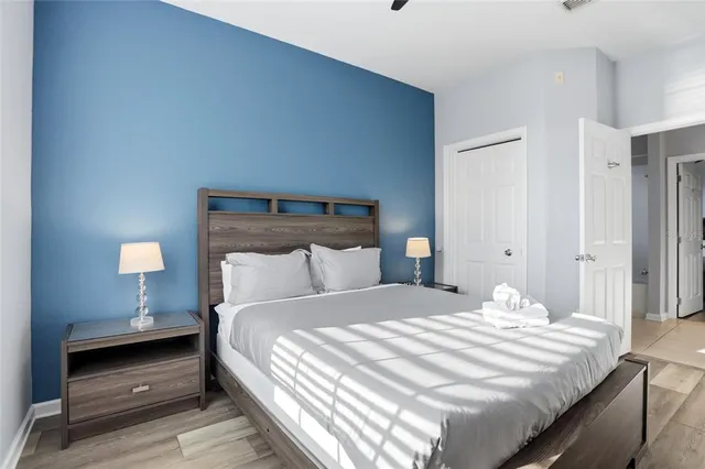 a bedroom with a bed and a lamp