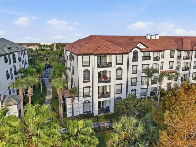 a front view of a residential apartment building with a yard