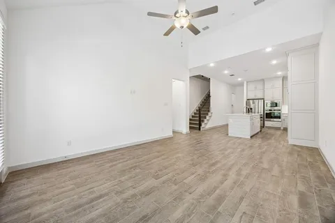 a view of empty room with wooden floor and window