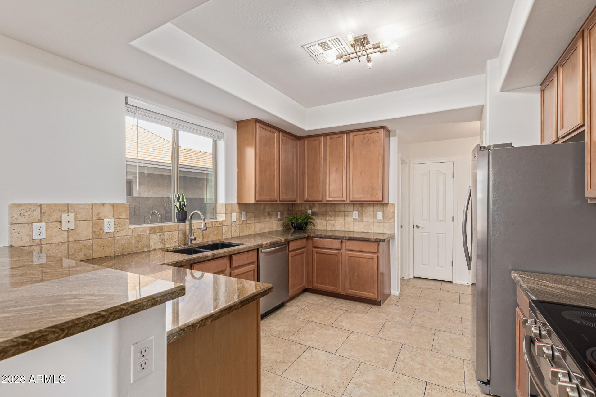 21324 Karsten Drive Maricopa, AZ 85138 - Photo 14 of 49 a kitchen with a sink stove and refrigerator
