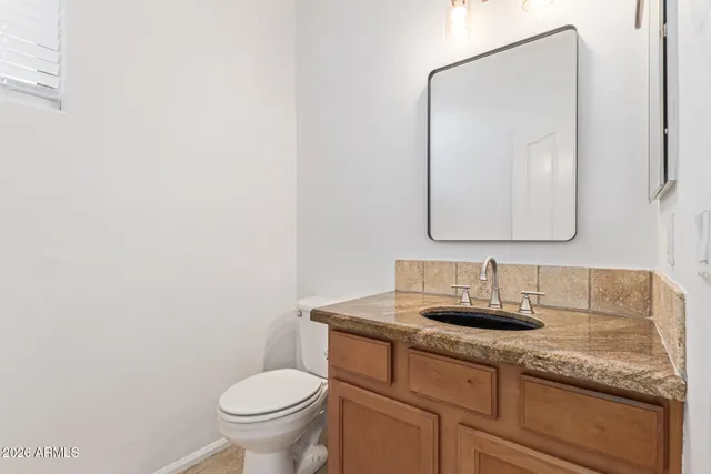 an empty room with a window and a ceiling fan
