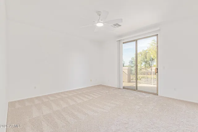 an empty room with a ceiling fan and hardwood floor