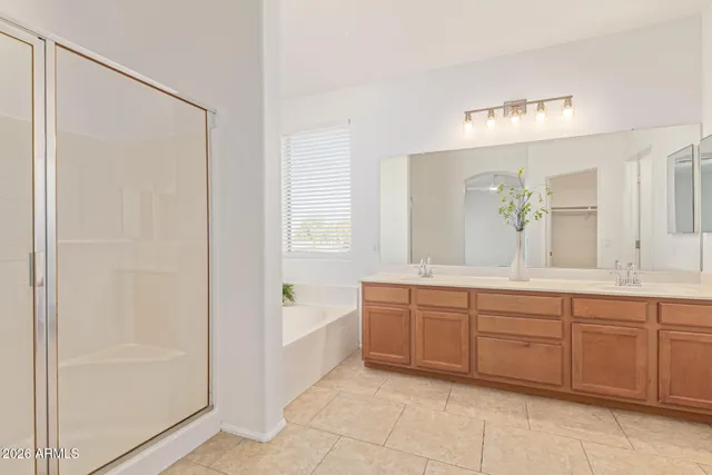 an empty room with a window and ceiling fan