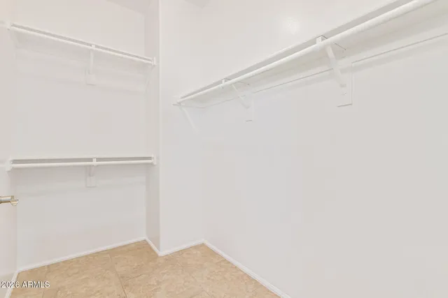 an empty room with a chandelier fan