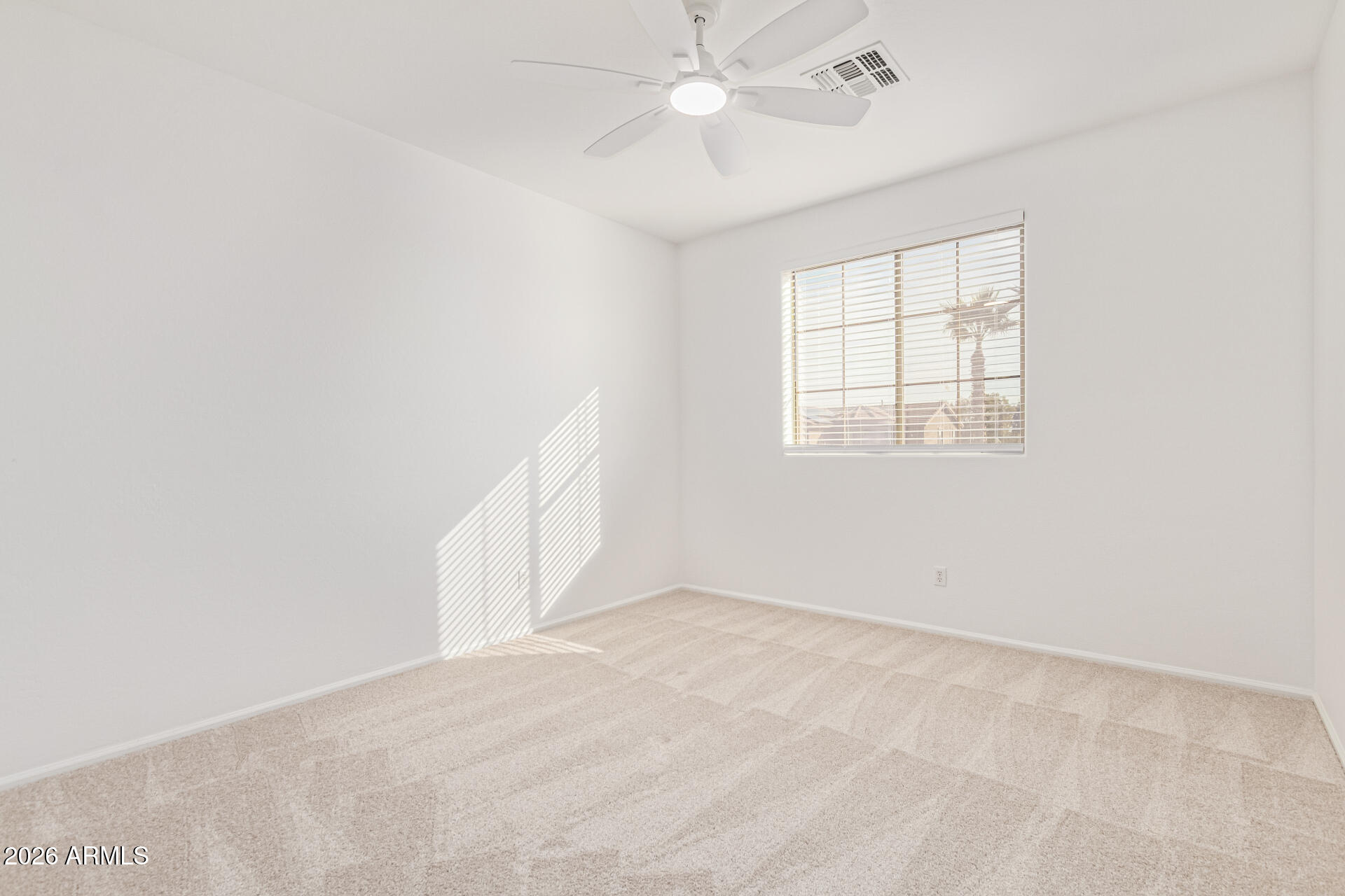 21324 Karsten Drive Maricopa, AZ 85138 - Photo 29 of 49 an empty room with a window and ceiling fan