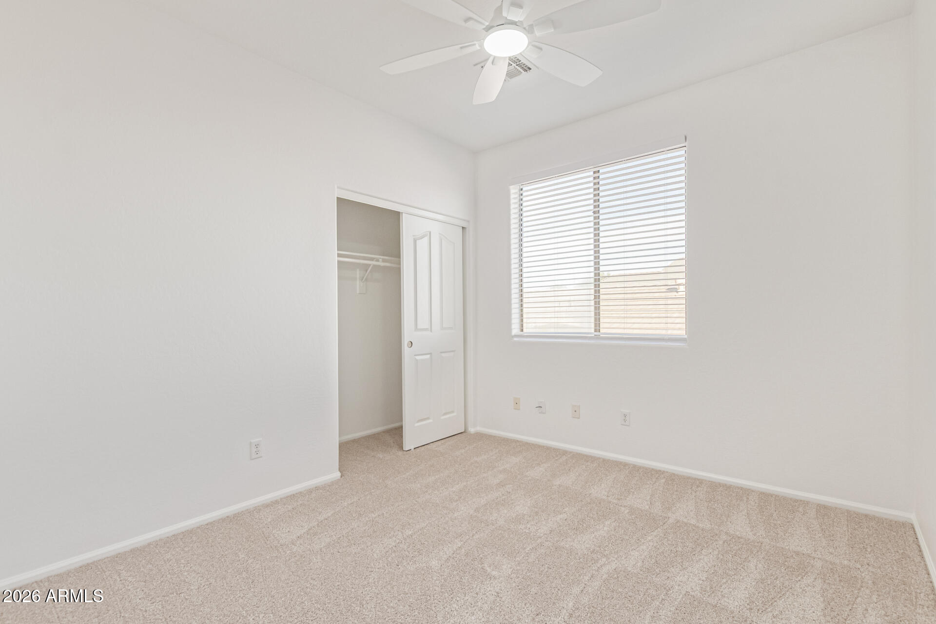 21324 Karsten Drive Maricopa, AZ 85138 - Photo 31 of 49 an empty room with a chandelier fan