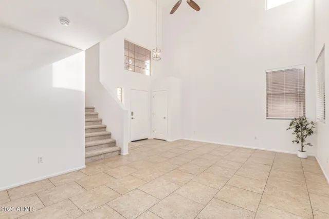 an empty room with closet and windows