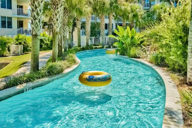 a view of a wooden house with a big yard and large trees