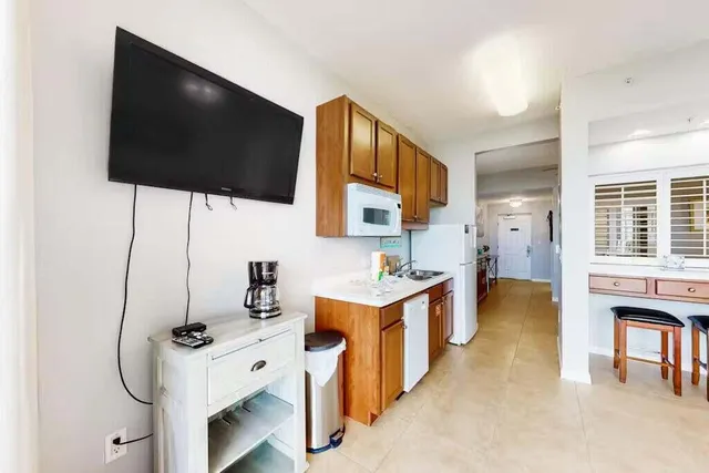 a bedroom with a large bed and a flat screen tv