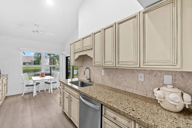 a kitchen with a sink cabinets and a wooden floor