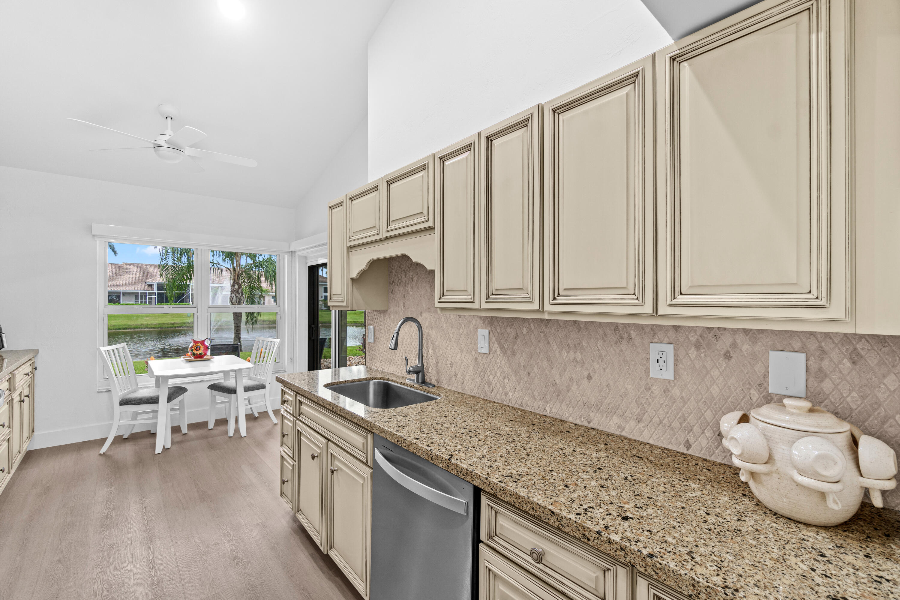 5097 Windsor Parke Drive Boca Raton, FL 33496 - Photo 12 of 30 a kitchen with a sink cabinets and a wooden floor