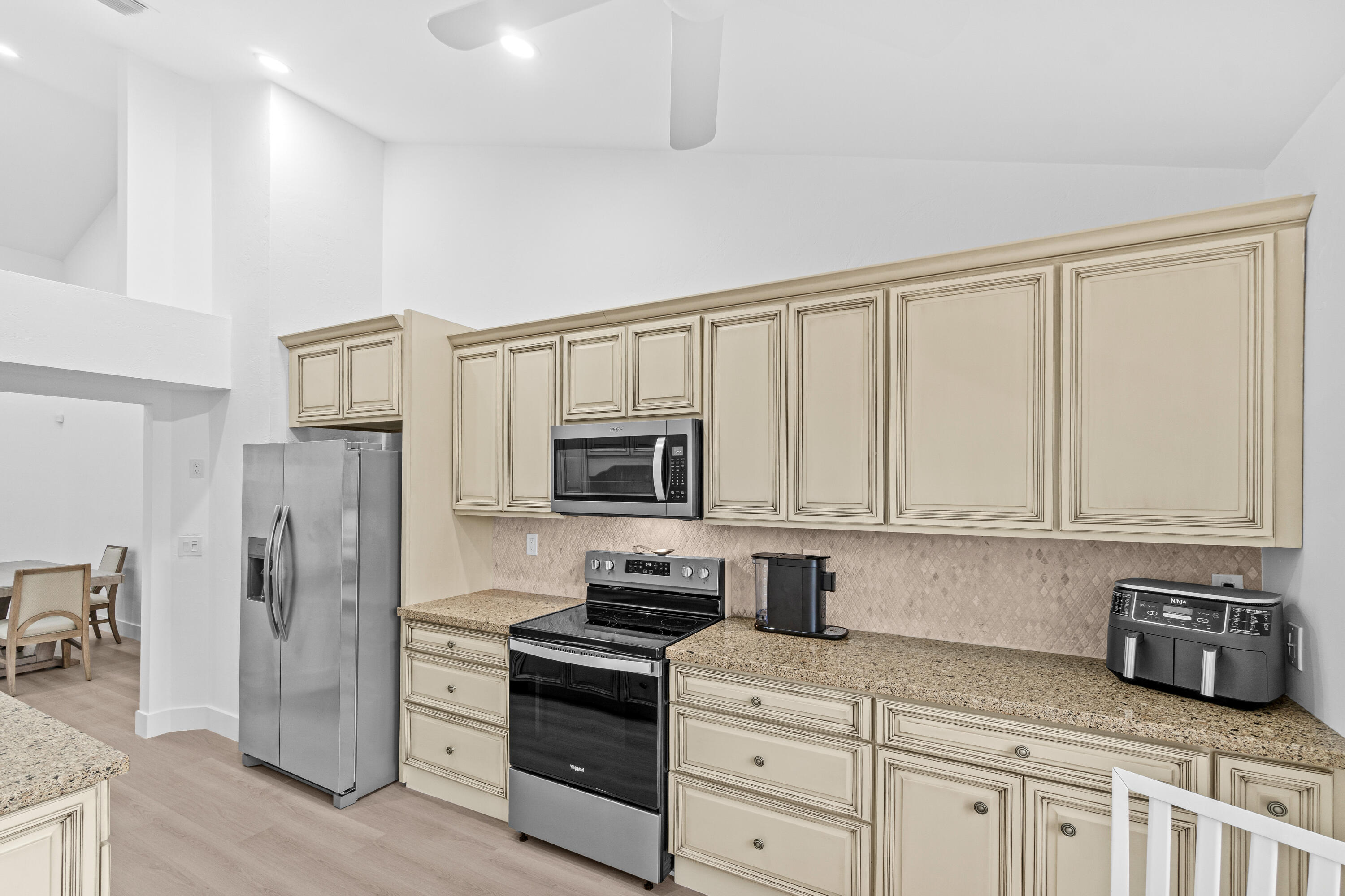 5097 Windsor Parke Drive Boca Raton, FL 33496 - Photo 16 of 30 a kitchen with stainless steel appliances granite countertop a refrigerator stove and sink