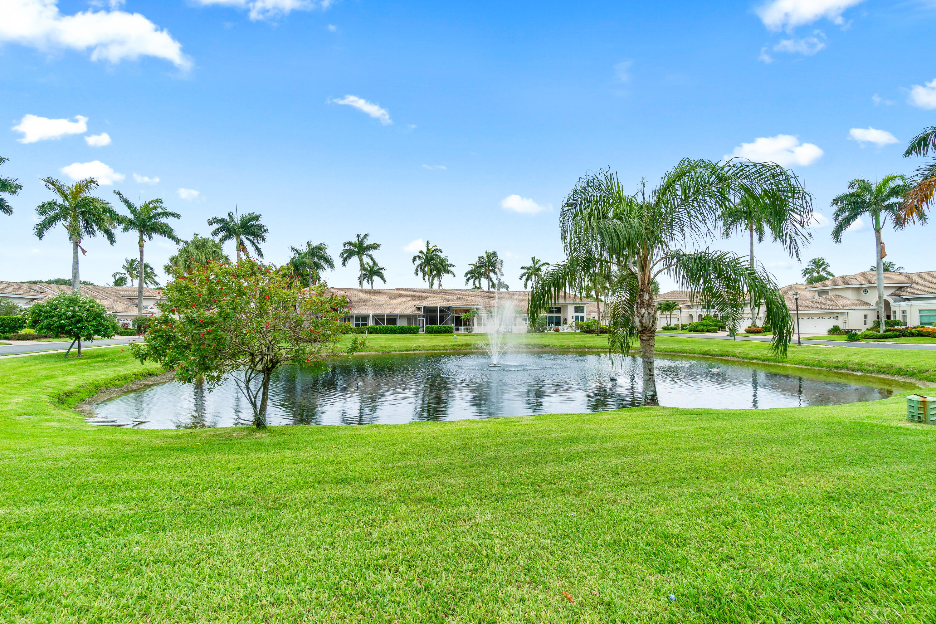 5097 Windsor Parke Drive Boca Raton, FL 33496 - Photo 28 of 30 a view of a lake with a park