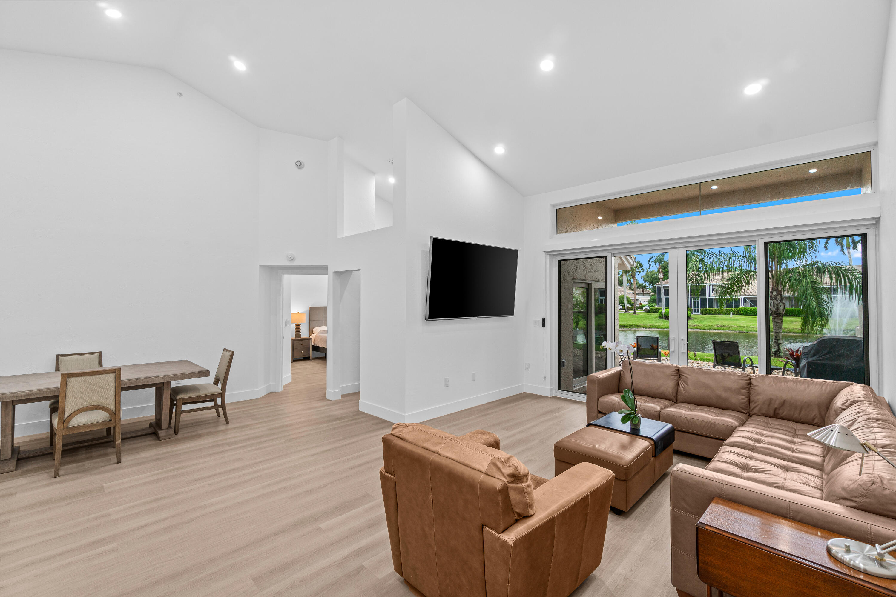 5097 Windsor Parke Drive Boca Raton, FL 33496 - Photo 6 of 30 a living room with furniture wooden floor and a flat screen tv