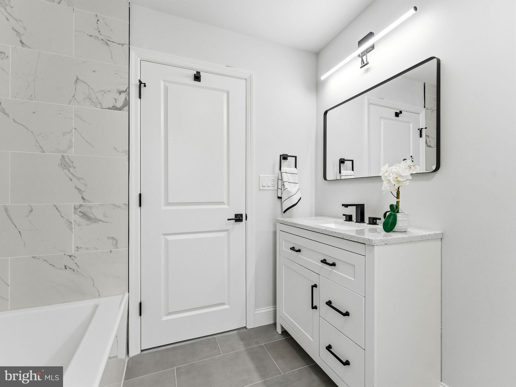 505 Greenwood Avenue Maple Shade, NJ 08052 - Photo 14 of 30 a bathroom with a bathtub sink and mirror