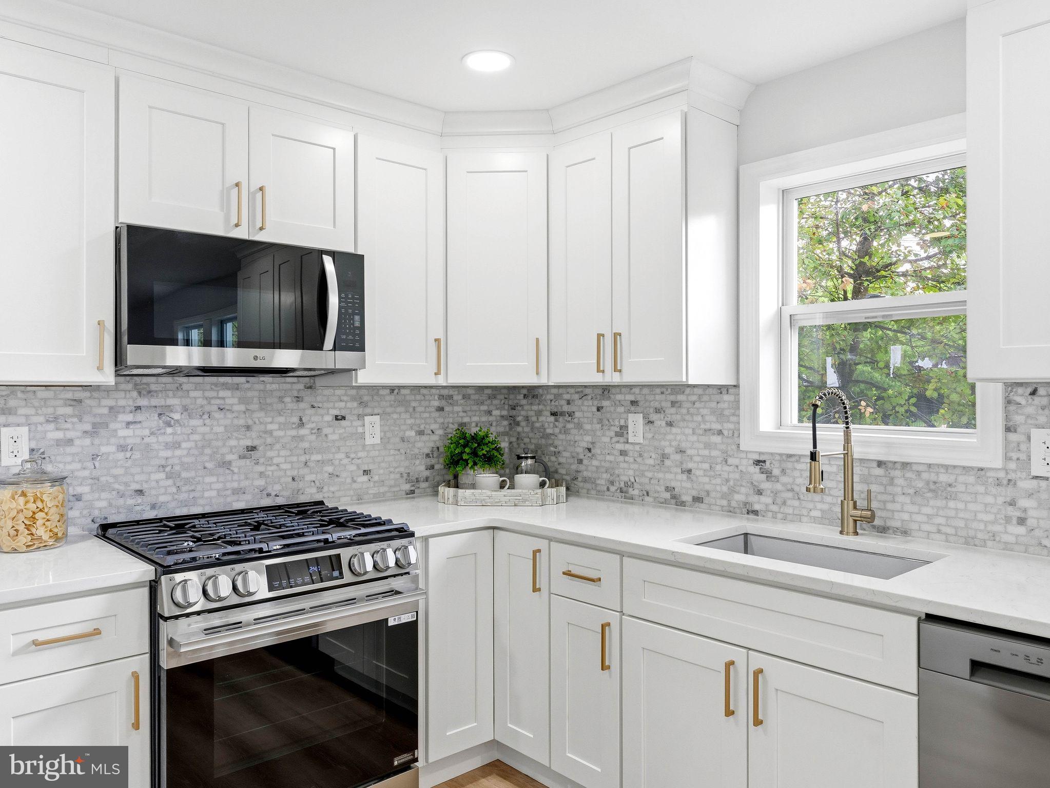 505 Greenwood Avenue Maple Shade, NJ 08052 - Photo 9 of 30 a kitchen with stainless steel appliances granite countertop white cabinets a sink and a stove