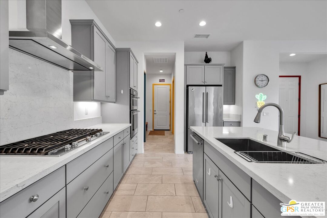30 Cabernet Rancho Mirage, CA 92270 - Photo 18 of 31 a kitchen with stainless steel appliances granite countertop a sink stove and refrigerator
