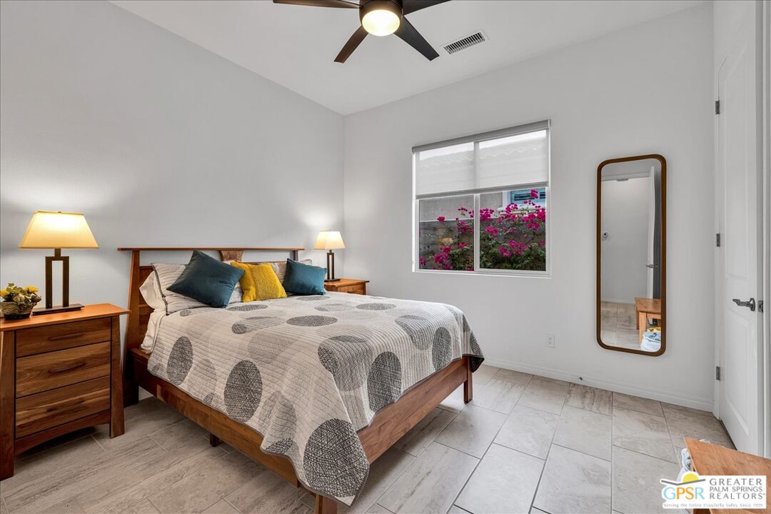 30 Cabernet Rancho Mirage, CA 92270 - Photo 22 of 31 a bedroom with a bed painting on wall and a large window