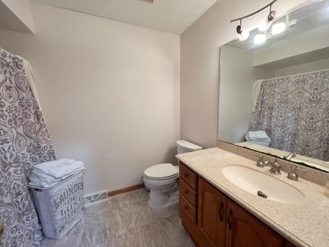 15286 Sharp Road Rockton, IL 61072 - Photo 19 of 19 a bathroom with a granite countertop sink a toilet and a mirror