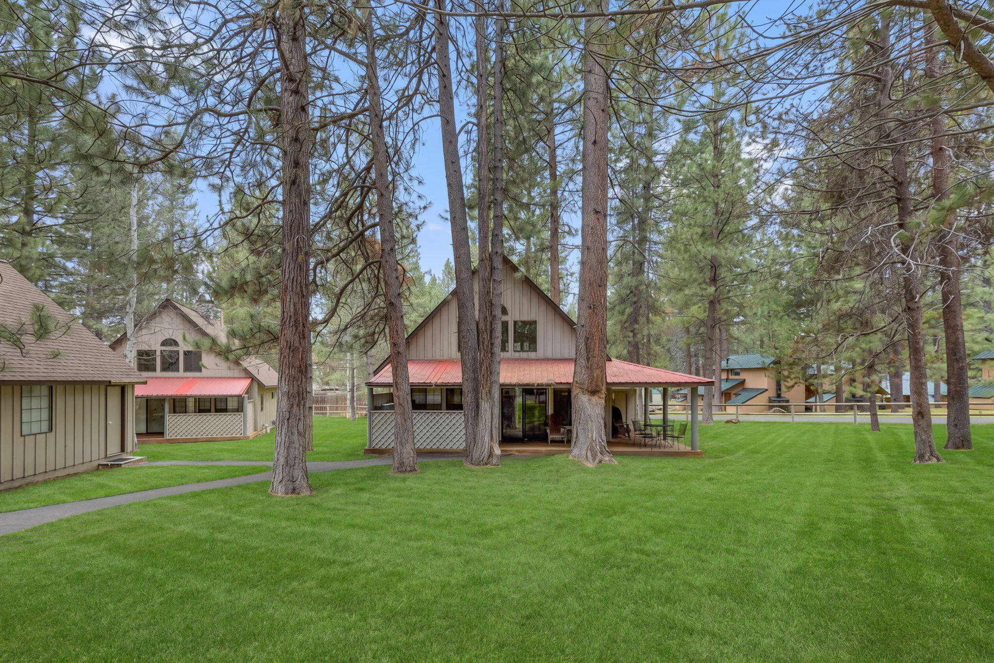 57505 Circle 4 Cabin Road, Unit 29 Sunriver, OR 97707 - Photo 3 of 35 a front view of a house with a yard and trees