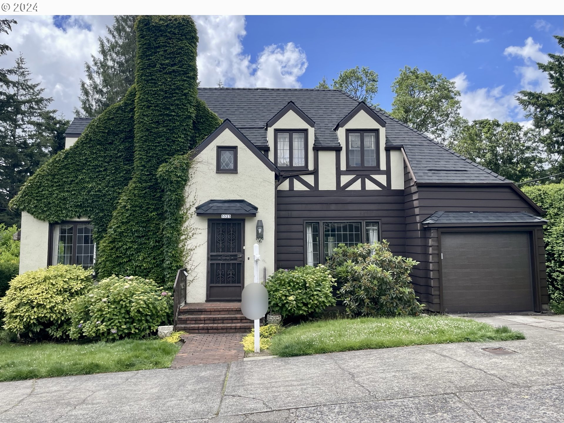 a front view of house with yard and green space