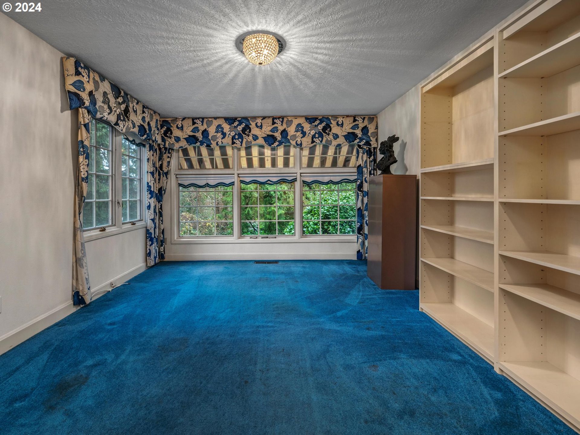 5523 Southwest Menefee Drive Portland, OR 97239 - Photo 12 of 22 wooden floor in an empty room with a window